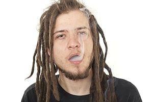 Young man with dreadlocks smoking